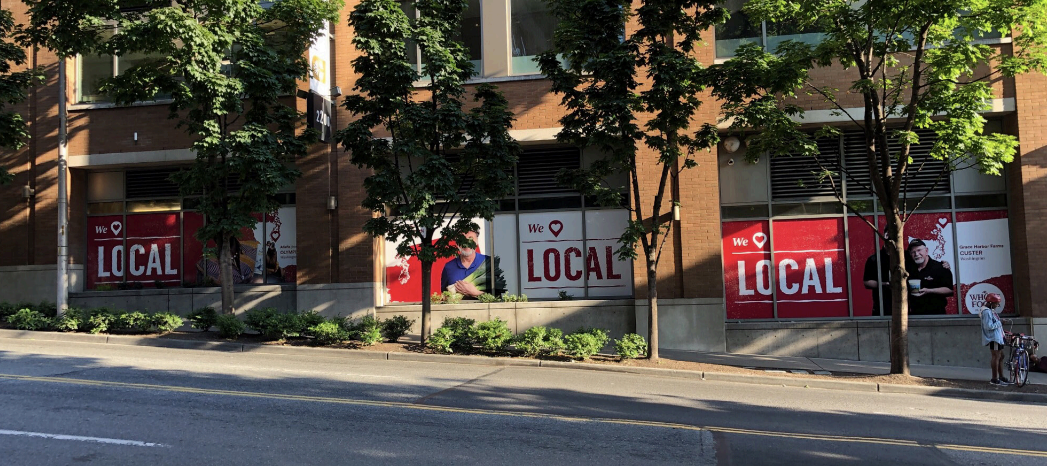 Whole Foods Market storefront wrapped in the We Love Local campaign